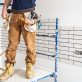 Professional in overalls with tools on the background of the repair site.