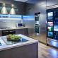 Modern kitchen with a digital display screen built into the refrigerator.