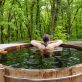 Beautiful woman in nordic bath in front of a forest.