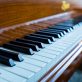 A closeup of A piano under the lights with a blurry background